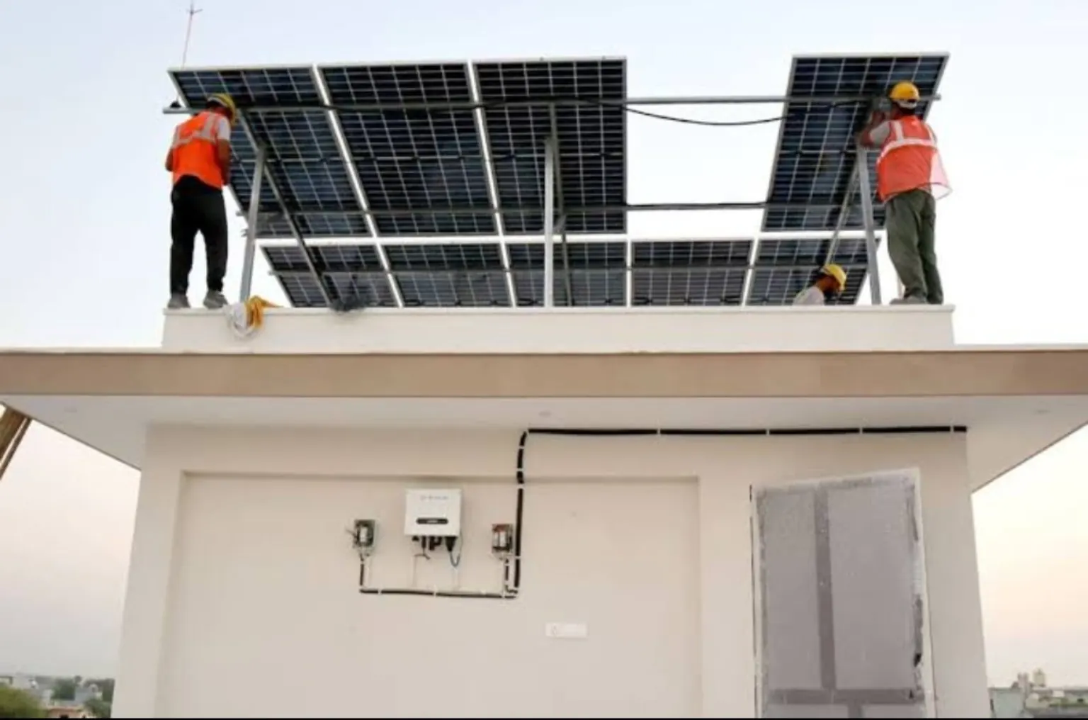 Technicians installing solar panels on a rooftop